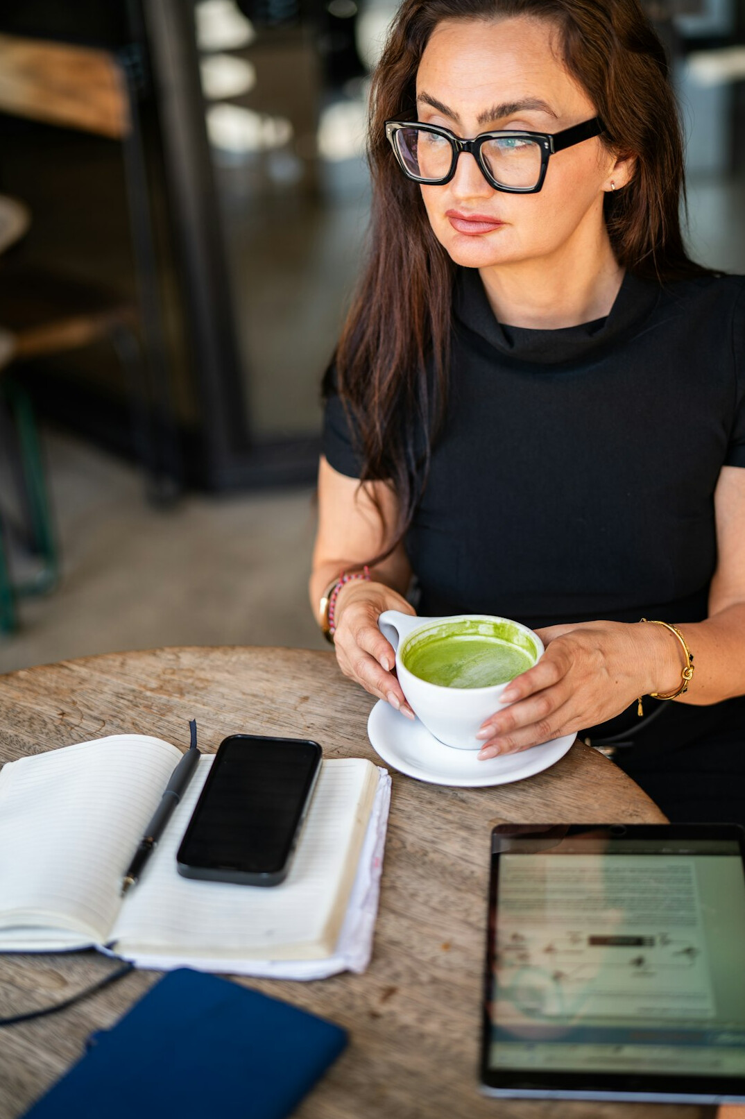 woman journaling in cafe